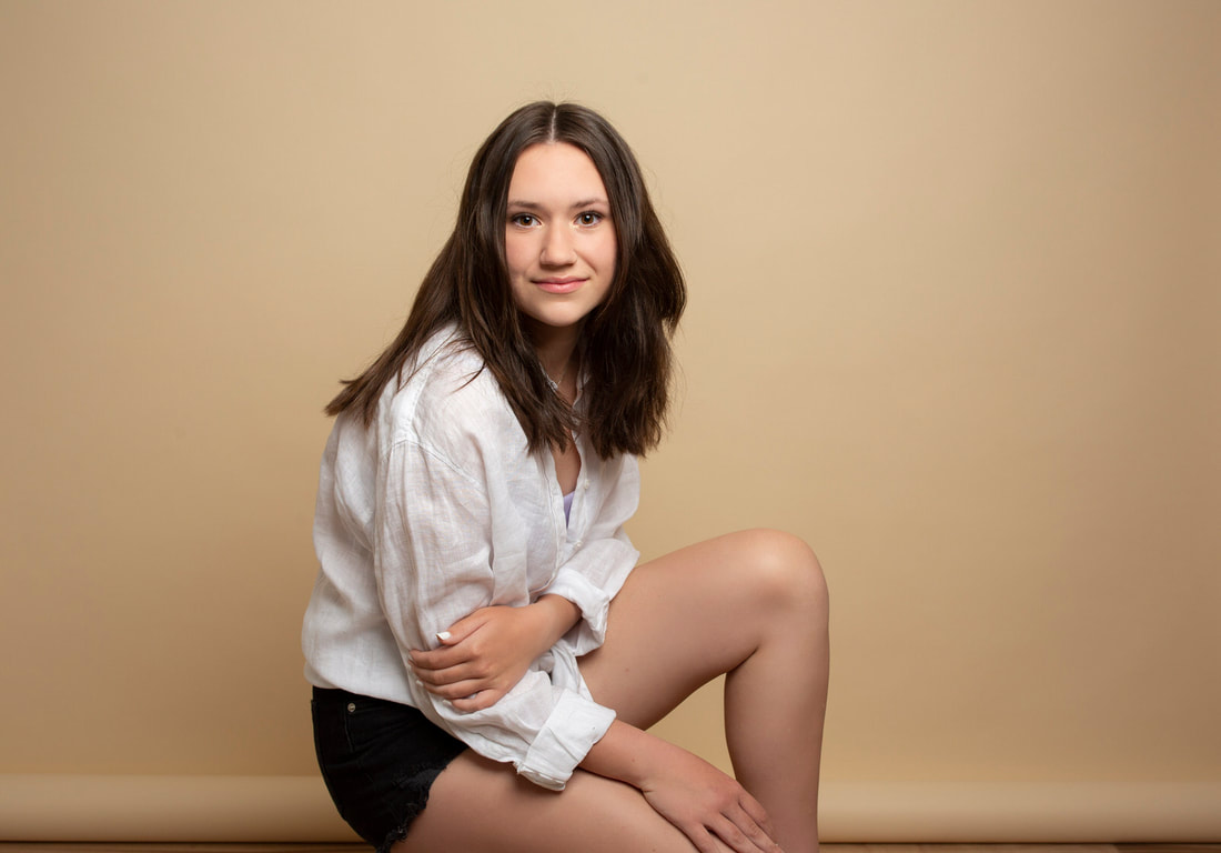 Portrait of teenage girl on beige background